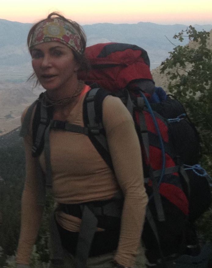 Kippy Hoene carrying a large red expedition backpack during the Mt. Whitney approach.